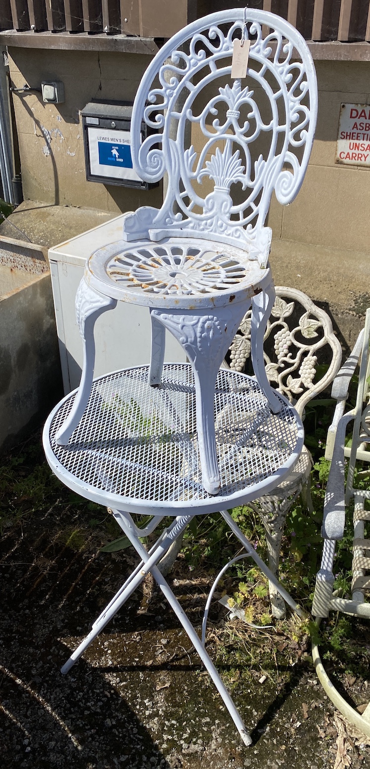 A circular folding metal bistro table, diameter 61cm, and two various chairs